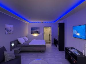 a living room with a couch and a tv at Themenpartment Himmel und Mehr Penthouse in Gelsenkirchen +16 photos