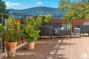 a deck with chairs and a table with plants at Agroturystyka Corno Owca in Żabnica