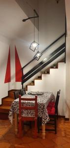 a dining room with a table with a cheetah print table cloth at Honeycomb - casa vacanze in Varese