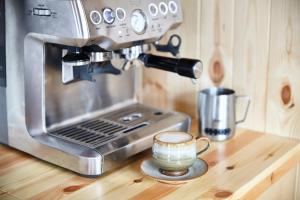 a coffee maker on a counter with a cup of coffee at Aileen - Unique tiny house with wood fired roll top bath in heart of the Cairngorms in Ballater