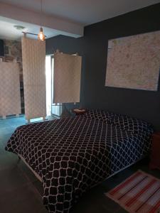 1 dormitorio con 1 cama con edredón negro en Camino al Cuadrado en Río Ceballos