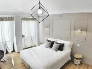 En eller flere senge i et værelse på QUARTA GENERAZIONE - Apartment