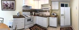 a kitchen with white appliances and white cabinets at Two bedroom apartment in single family home in Fort Washington