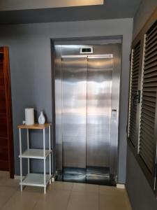 a stainless steel elevator in a room with a shelf at Fuerteventura in Loft in Gran Tarajal