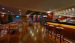 a bar with wooden floors and bar stools in a restaurant at Royale Chulan Damansara in Petaling Jaya