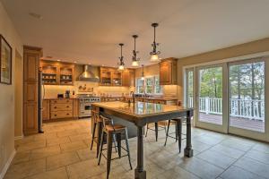 a large kitchen with a large wooden table and chairs at Beautiful Lakefront Retreat with Deck and Views! in Newton