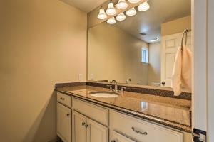 a bathroom with a sink and a large mirror at Beautiful Lakefront Retreat with Deck and Views! in Newton +30 photos