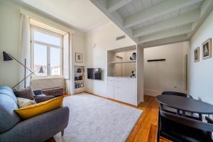 a living room with a couch and a table at Casa do Cativo in Porto +29 photos