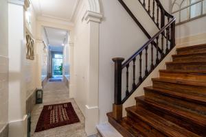a hallway with a staircase with wooden railings at Casa do Cativo in Porto
