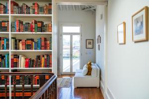 a room with a book shelf filled with books at Casa do Cativo in Porto