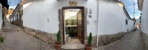 a door to a building with a sign on it at Gaia House Hostel in Cusco