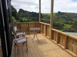 a wooden balcony with a table and chairs on it at Wild Days Accommodation in Palm Beach