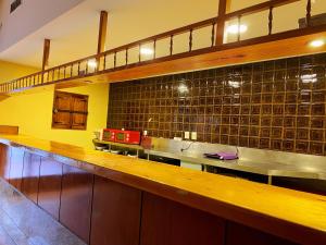 a kitchen with a long counter in a restaurant at Hostel Napoles in Madrid