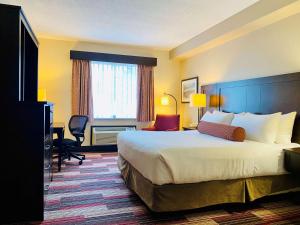 a hotel room with a bed and a desk at Best Western Plus Stoneridge Inn & Conference Centre London Ontario in London