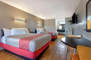 a hotel room with two beds and a table at Motel 6-Cookeville, TN in Cookeville +94 photos