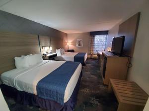 a hotel room with two beds and a flat screen tv at Best Western Historic Frederick in Frederick +4 photos