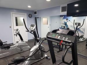 a gym with three tread machines in a room at Best Western Historic Frederick in Frederick