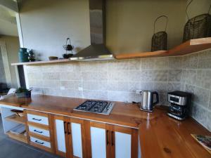 a kitchen with a wooden counter top with a stove at CABAÑA NORDICA in Los Laureles