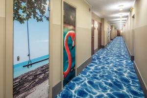 a hallway with a floor in the water with a red swan on it at Scandic The Reef in Frederikshavn