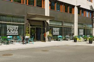 a building with tables and chairs outside of it at Scandic Park Helsinki in Helsinki