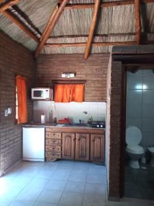 a kitchen with a sink and a stove top oven at Complejo Los Ciruelos in San Rafael