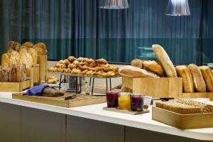 a table topped with lots of different types of bread at Scandic Oslo Airport in Gardermoen