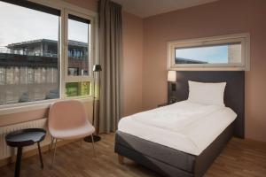 a hotel room with a bed and a window at Scandic Solsiden in Trondheim