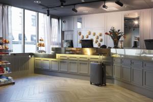 a large kitchen with a counter with a luggage at Scandic Rubinen in Gothenburg