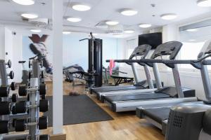 a gym with rows of treadmills and machines at Scandic Rubinen in Gothenburg