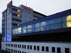 a building with a sign on the side of it at Scandic Alvik in Stockholm