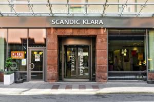 a building with a sign on the front of it at Scandic Klara in Stockholm