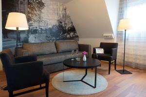 a living room filled with furniture and a fireplace at Scandic Sundsvall City in Sundsvall