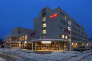 a building with a sign on the front of it at Scandic Kirkenes in Kirkenes