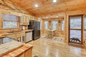 a kitchen and dining room in a log cabin at Hillside Haven in Blue Ridge