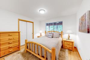 a bedroom with a bed and a dresser and a window at Tahoe's Stunner in Tahoe Vista