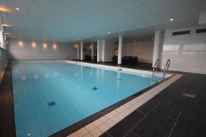 a large swimming pool in a building at Frichs Hotel Hamar in Hamar