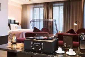 a hotel room with a bed and a table with a dj at Haymarket by Scandic in Stockholm