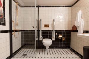 a bathroom with a toilet, sink, and shower stall at Haymarket by Scandic in Stockholm