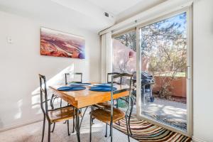 a dining room with a table and chairs and a window at Canyon Wind Casita in Moab