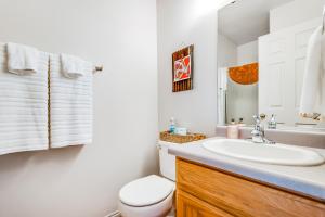 a bathroom with a white sink and a toilet at Canyon Wind Casita in Moab