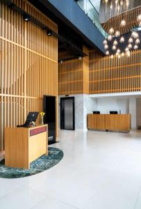 a large lobby with wooden walls and a desk at Park Inn by Radisson, Nairobi Westlands in Nairobi
