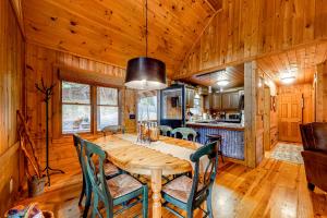 a dining room with a wooden table and chairs at Rushing River in Ellijay