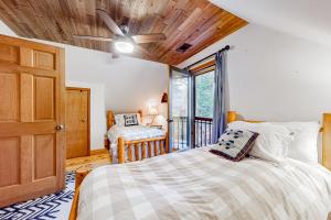 a bedroom with a bed and a ceiling fan at Rushing River in Ellijay
