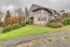 a house on a hill with a yard at The Queens Slopeside Hideaway in Jay