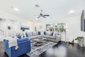 a living room with a blue couch and a table at The Bonita Rita - Magnum in Bonita Springs