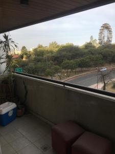 a balcony with a window with a view of a street at Departamento amoblado nueva Córdoba in Cordoba