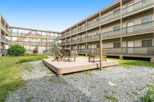 a building with chairs and tables in front of it at Pinnacle in Beech Mountain