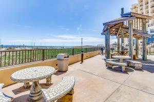 a patio with tables and chairs and a gazebo at Phoenix Vacation Rentals in Orange Beach