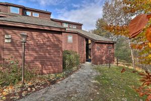 a house with a garage next to a building at Kettle Brook G in Ludlow