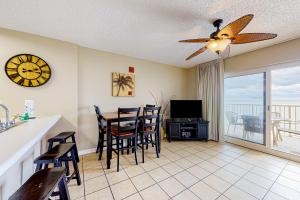 a kitchen and dining room with a table and a clock at Tradewinds Condos II in Orange Beach